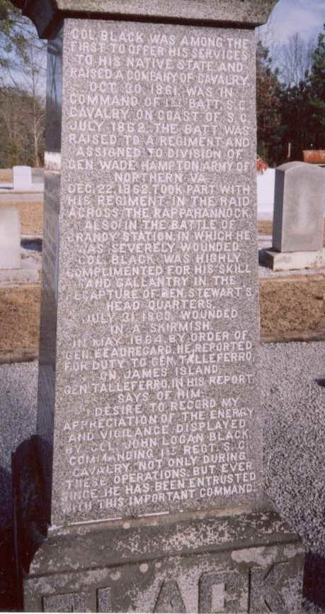 Tall granite monument with a long inscription in memory of Col. John Logan Black