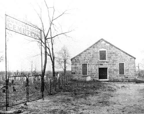 Old photograph of the stone church and churchyard at Duncan Creek