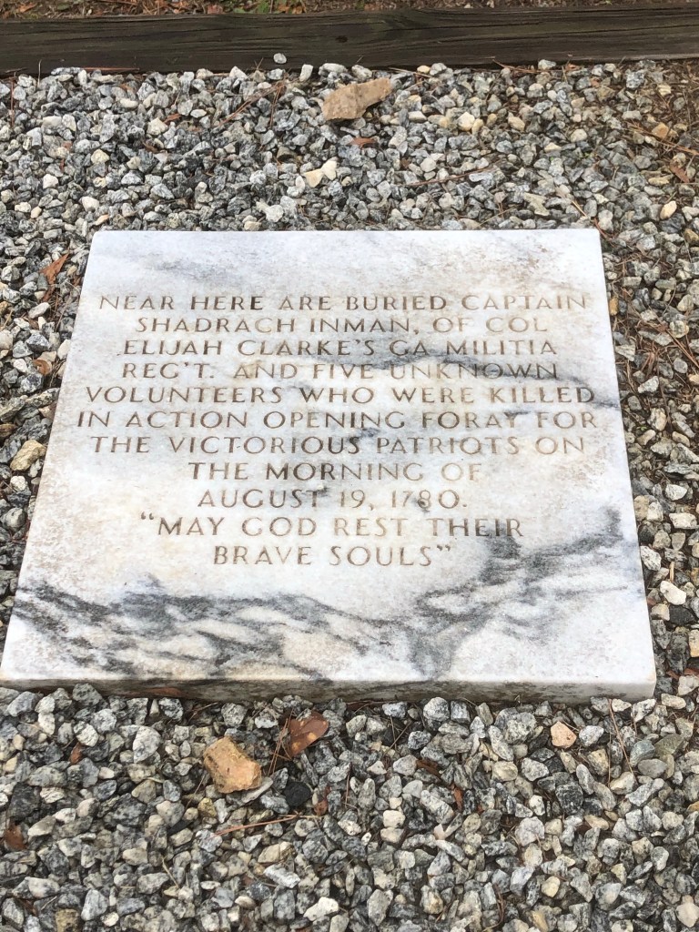 Marble marker in gravel for Captain Shadrach Inman and five unknown volunteers killed August 19, 1780