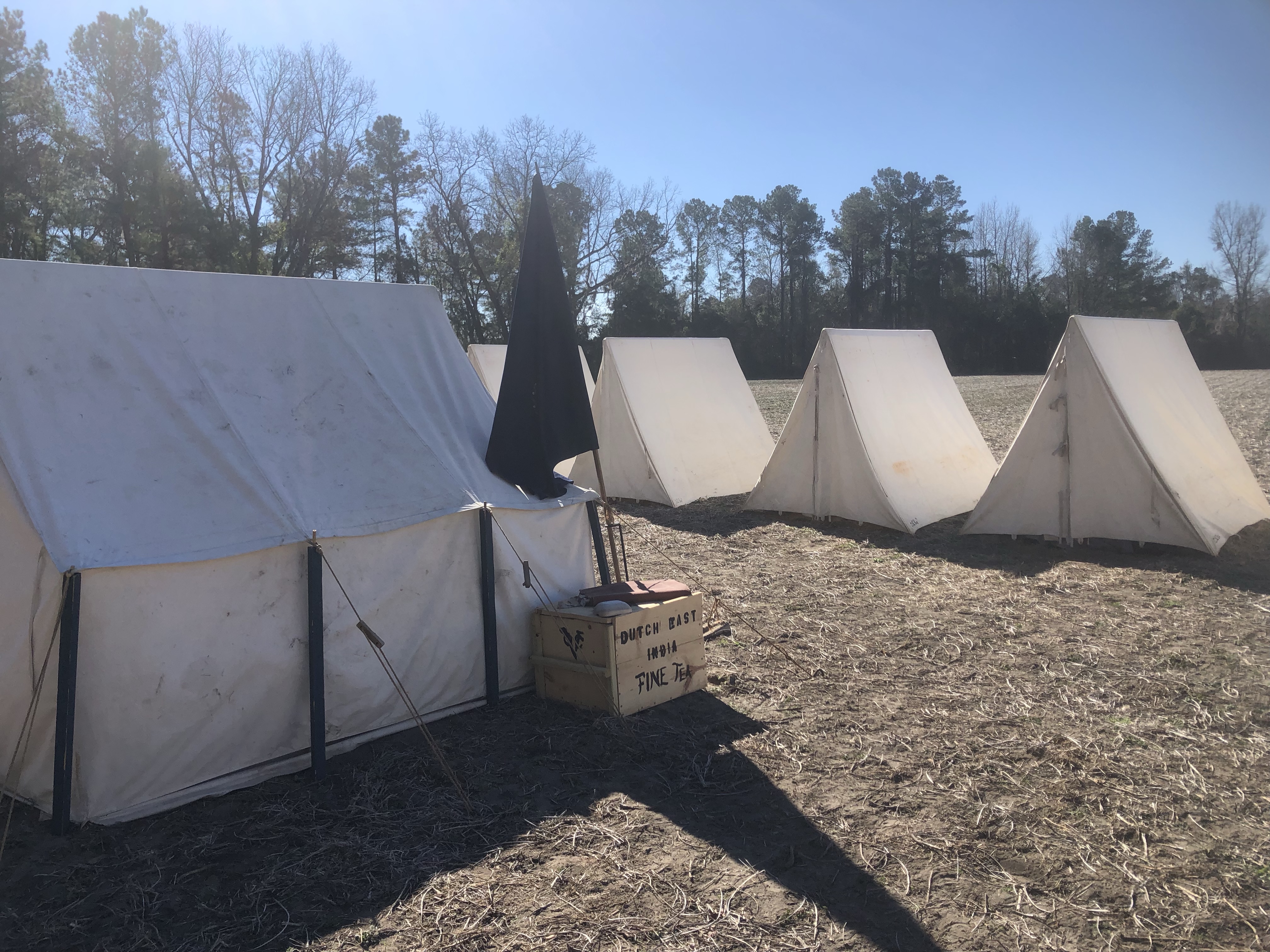 Wall tent and a line of wedge tents in the camp