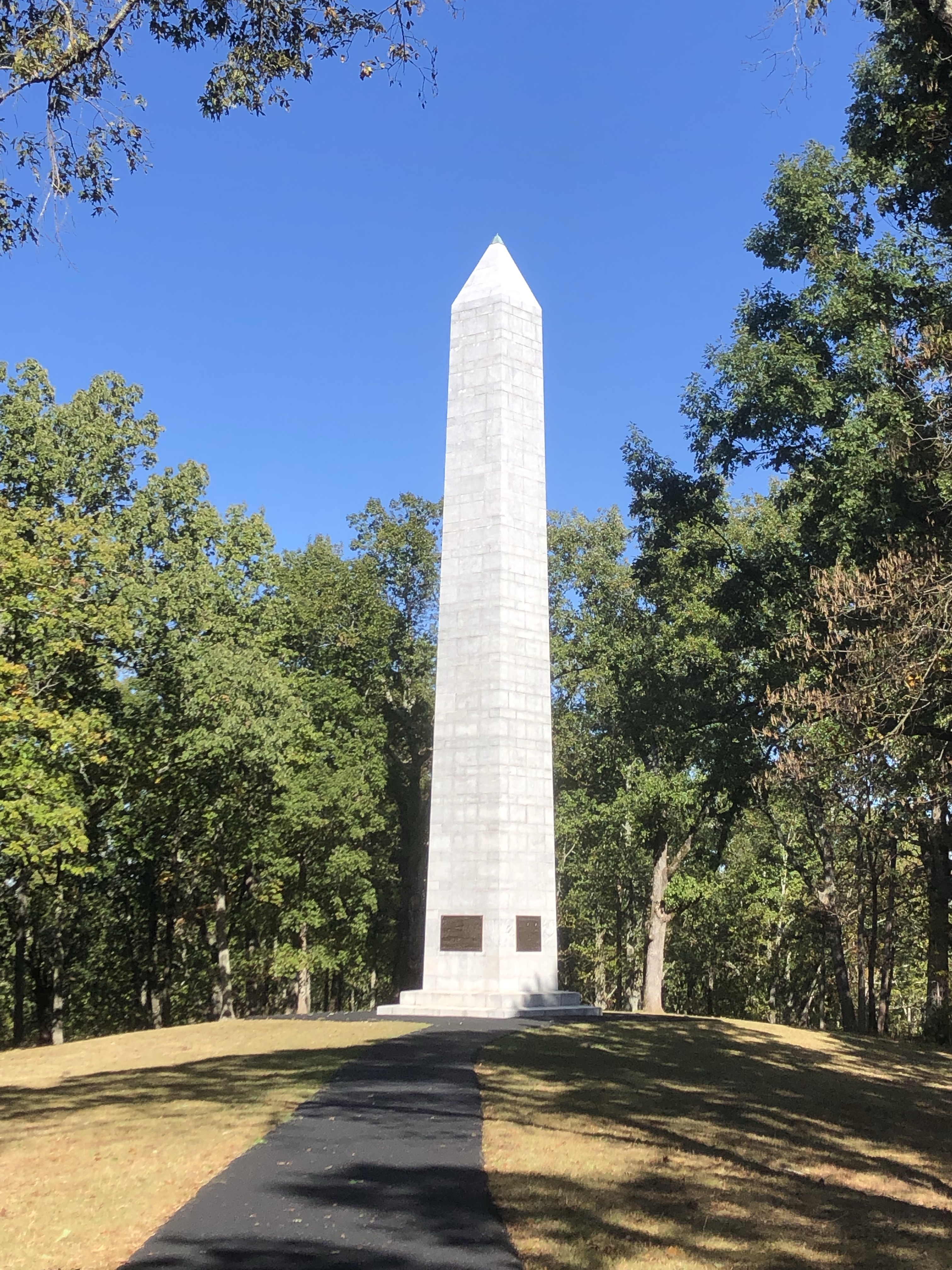 The tall granite Kings Mountain Monument obelisk under a blue sky