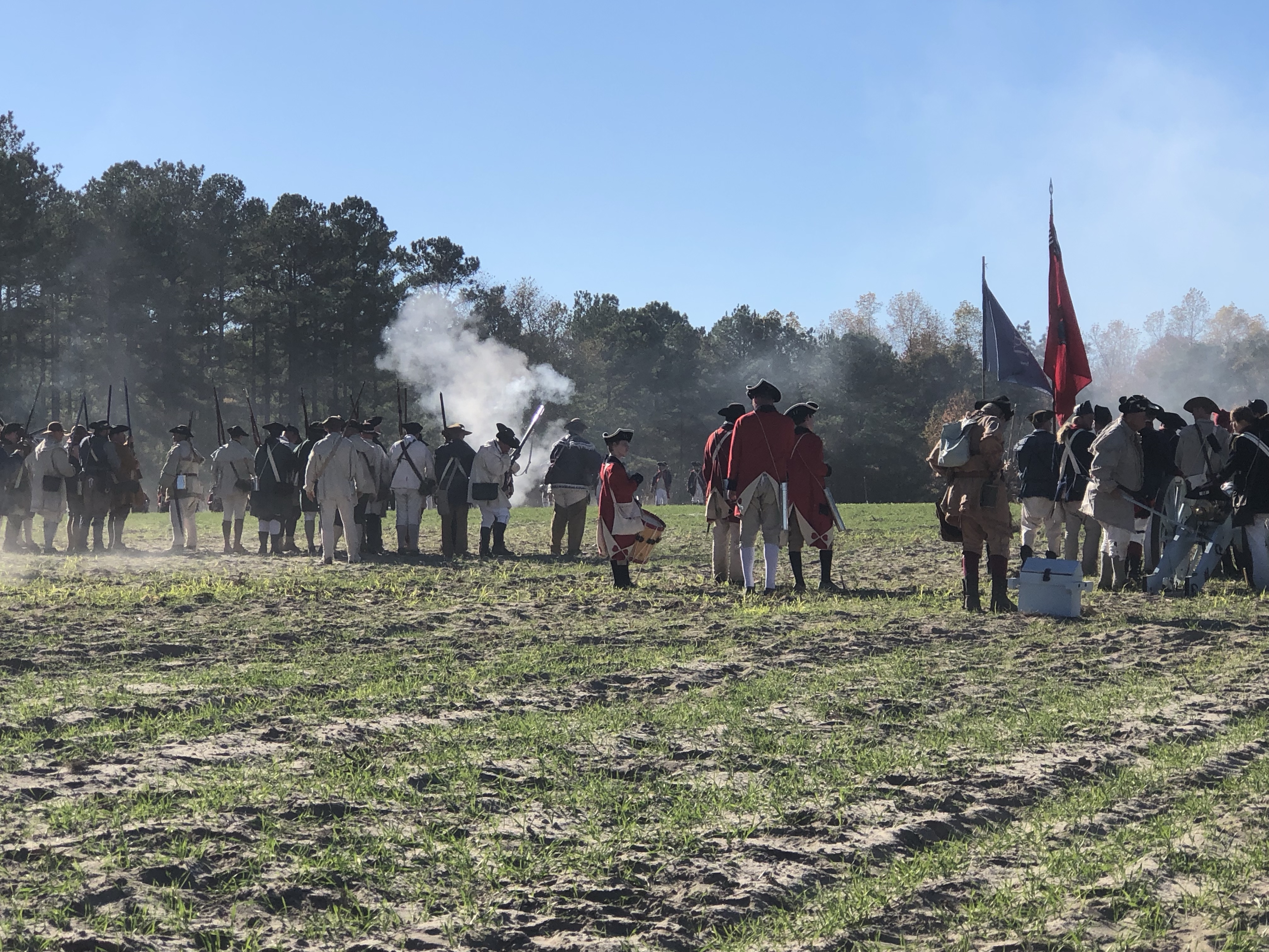 Battle lines facing each other with musket smoke and flags