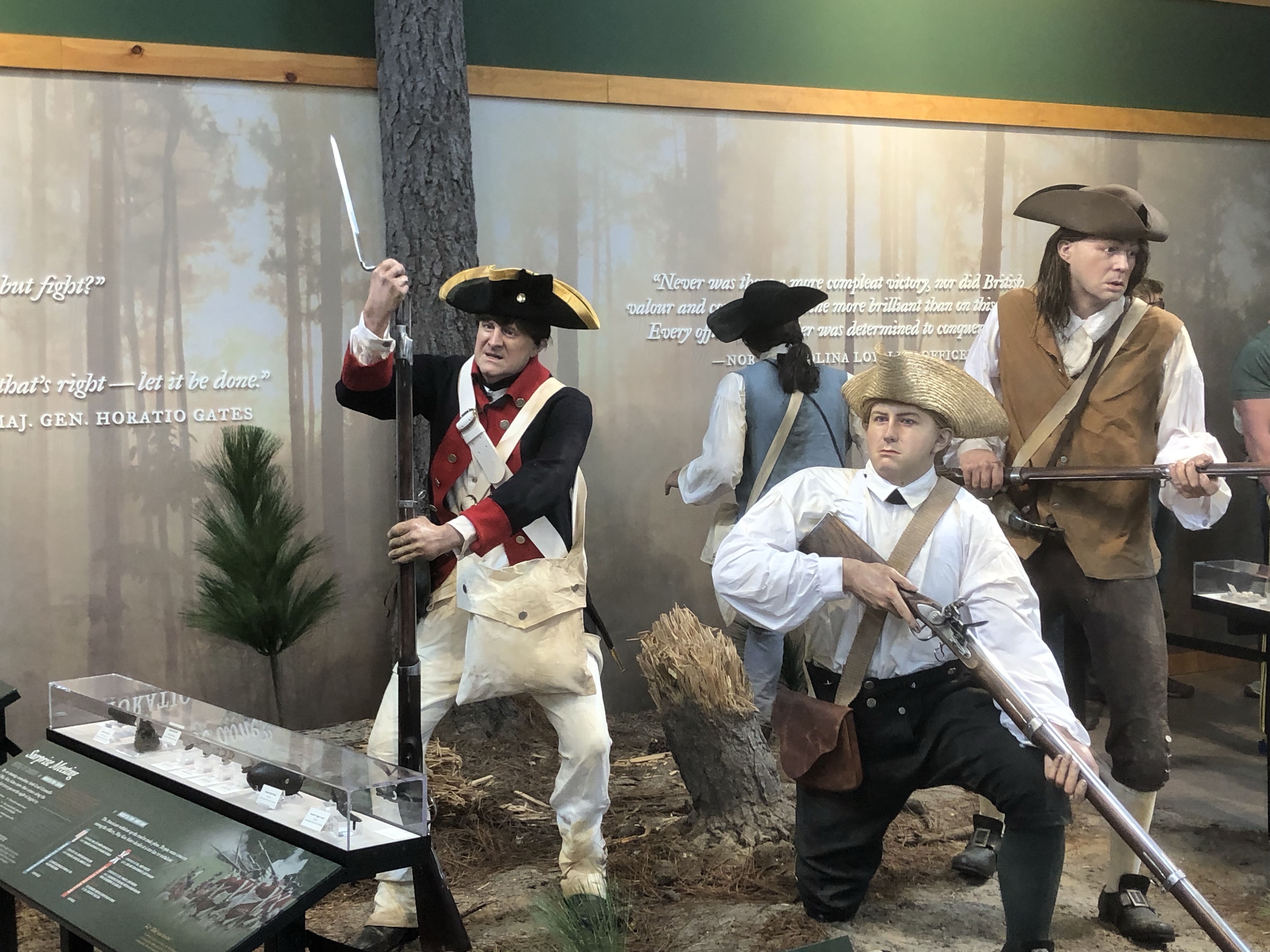 Museum exhibit of life-size Revolutionary War soldier figures with muskets