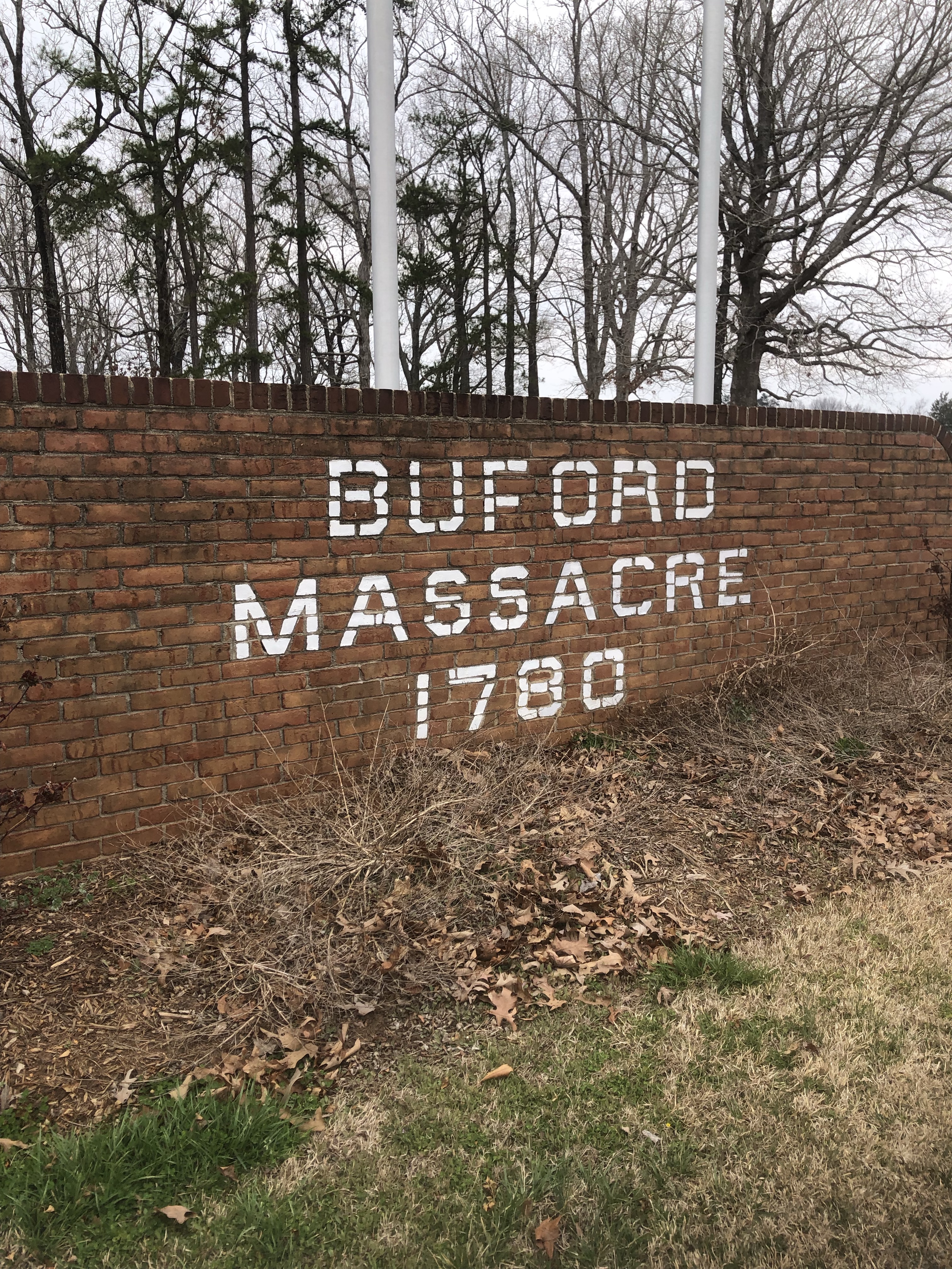 Brick wall with white letters reading Buford Massacre 1780