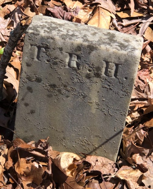 Footstone marked T.R.H., 2022