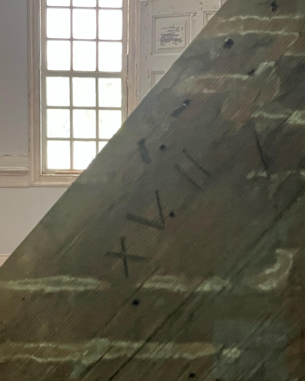 Roman numerals carved in a timber as carpenter's marks