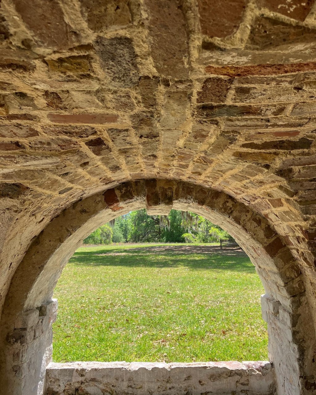 Brick arch in the foundation looking out to the lawn