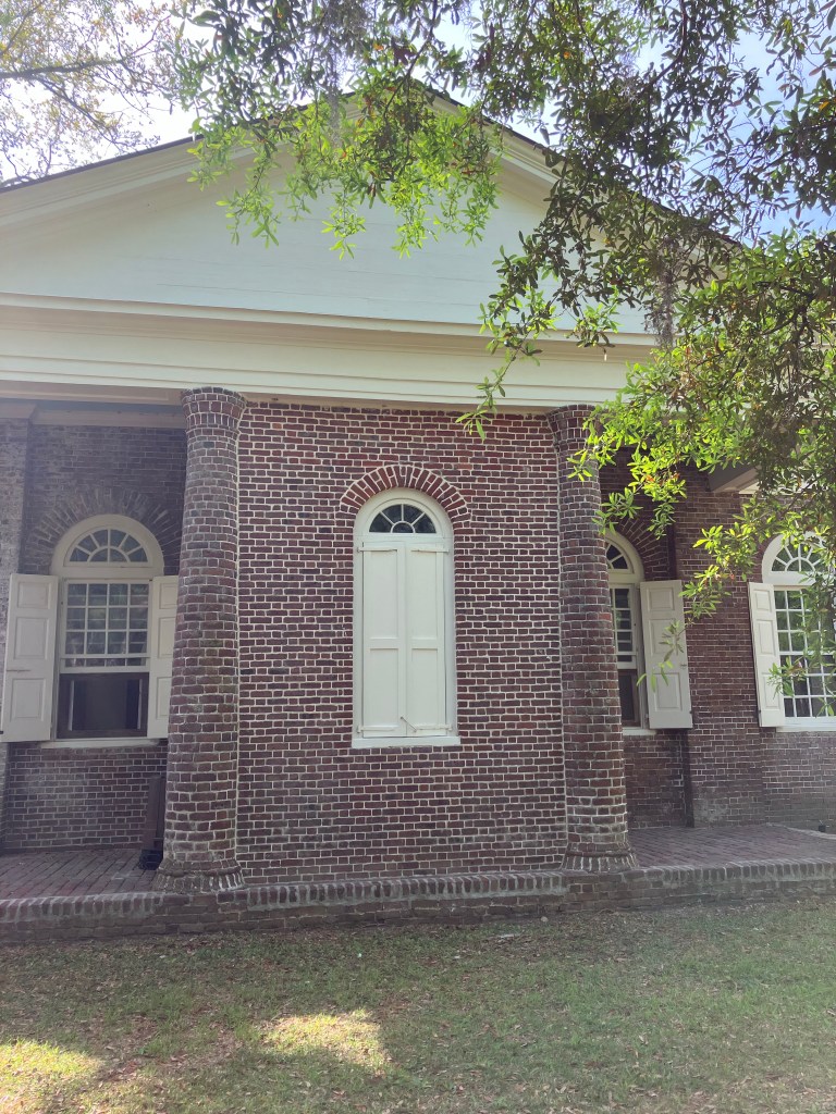The bricked-up second entrance on the side of the church