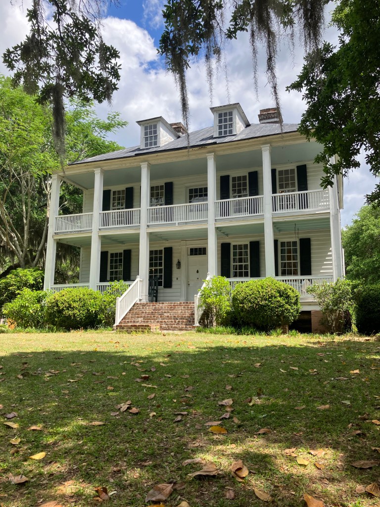 Hopsewee Plantation house with double porches and dormers under moss-draped oaks
