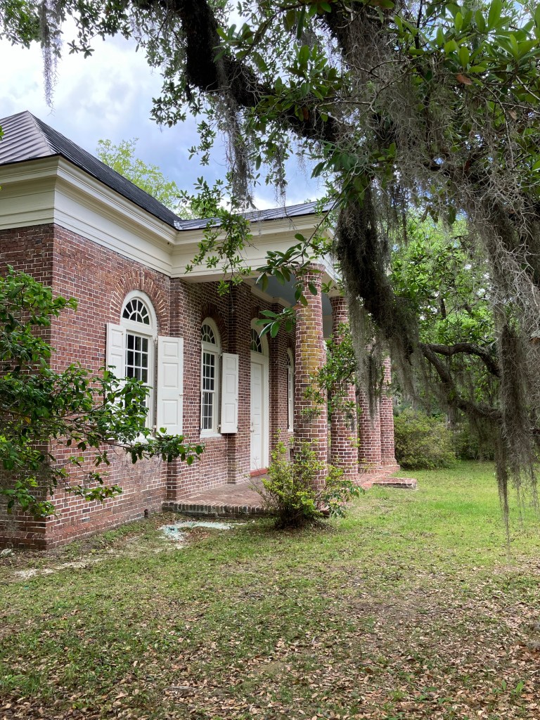 Brick St. James Santee Church with moss-draped live oaks
