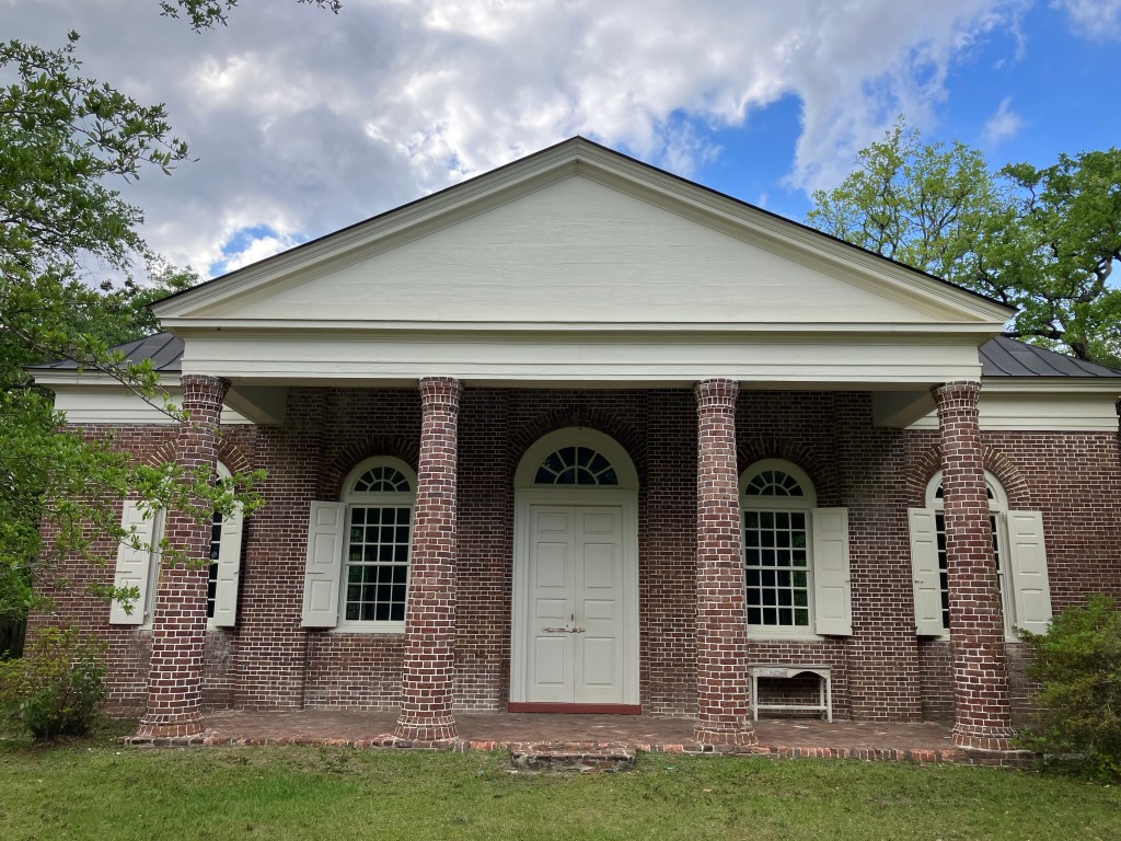 Front portico of the brick St. James Santee Church with its brick columns