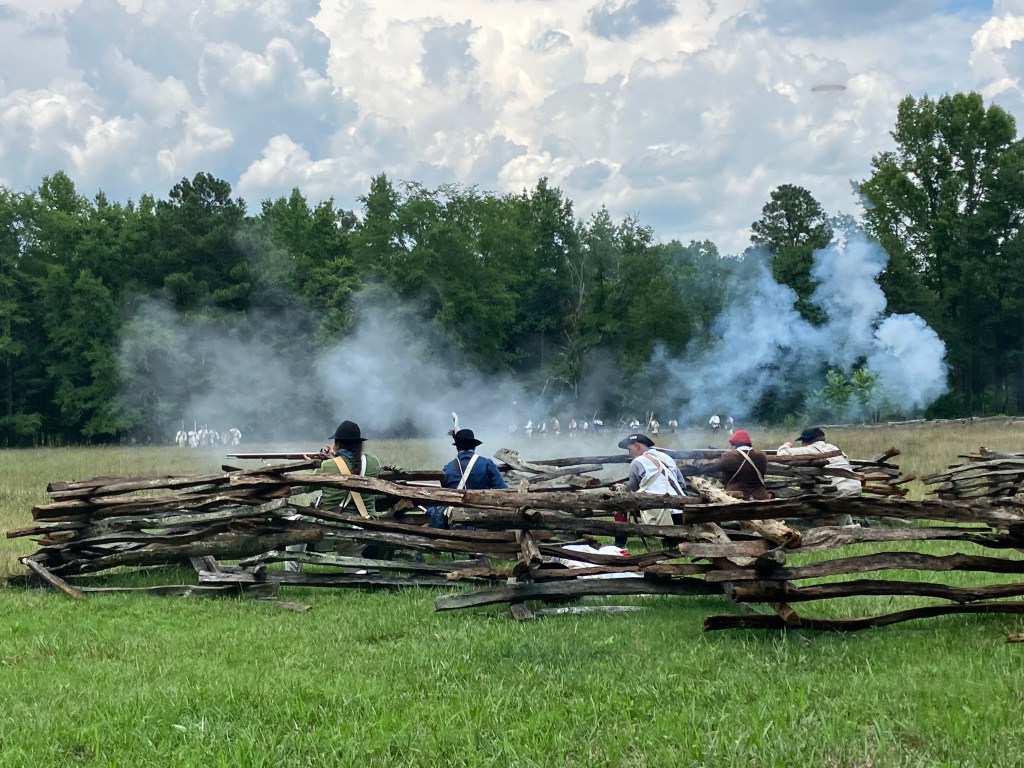 Smoke rising from a musket volley along the rail fence at Huck's Defeat