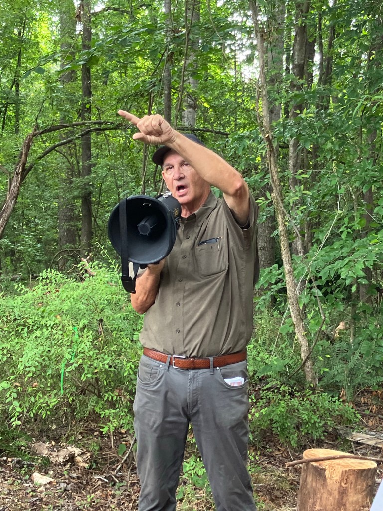 Durant Ashmore with a megaphone pointing across the Hammond's Old Store battlefield