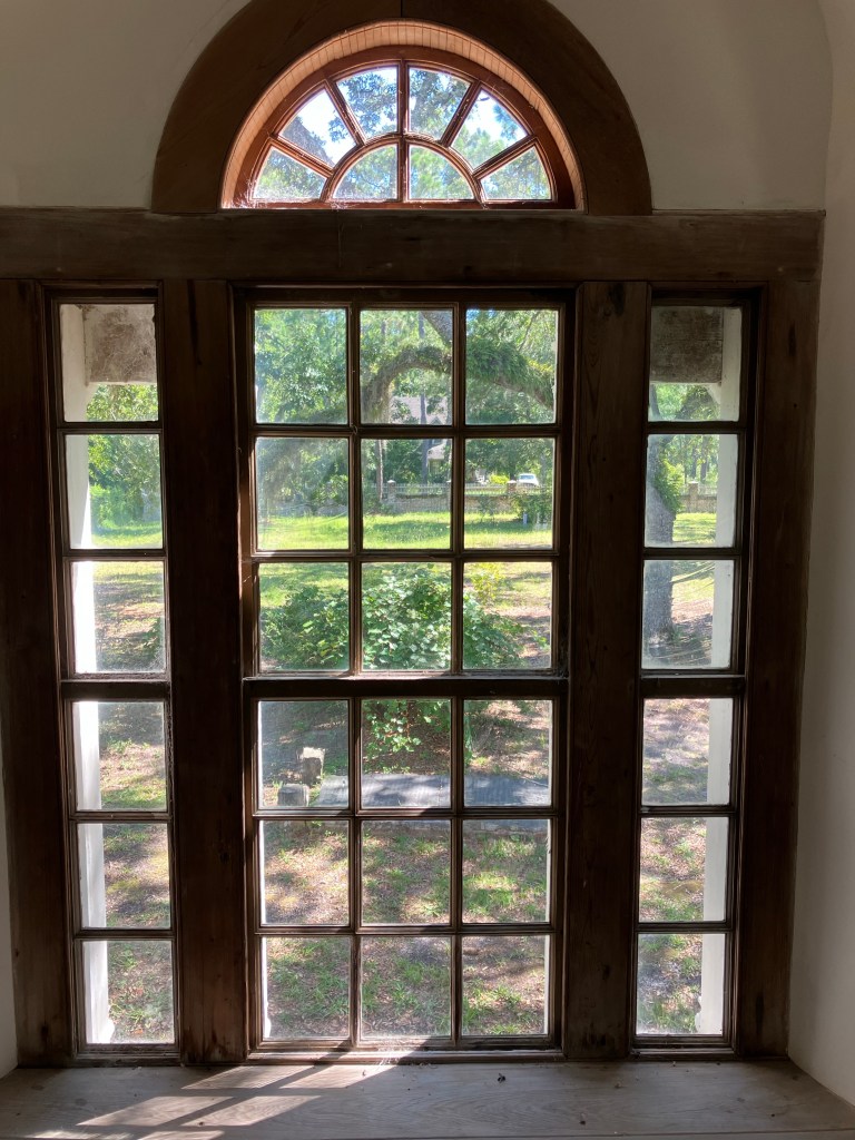 Tall window with a fanlight and paneled shutters