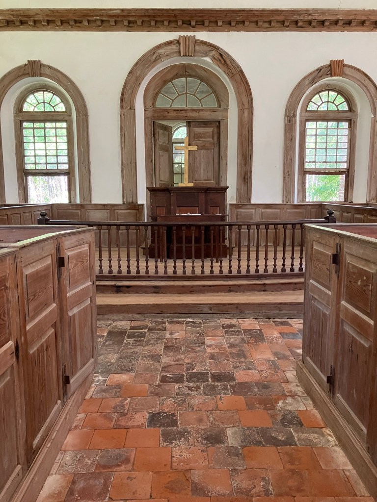 Arched windows and pulpit behind the chancel rail