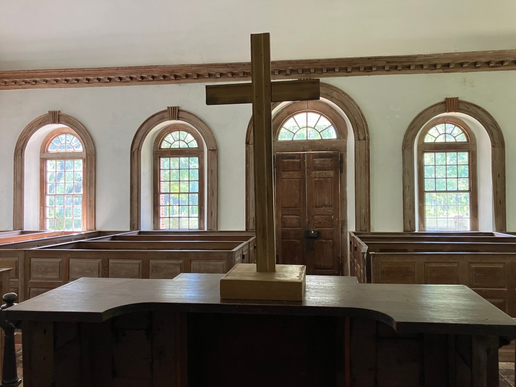 Plain wooden cross on the altar table
