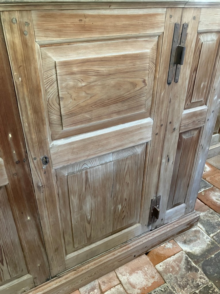 Close view of a weathered pew door and floor