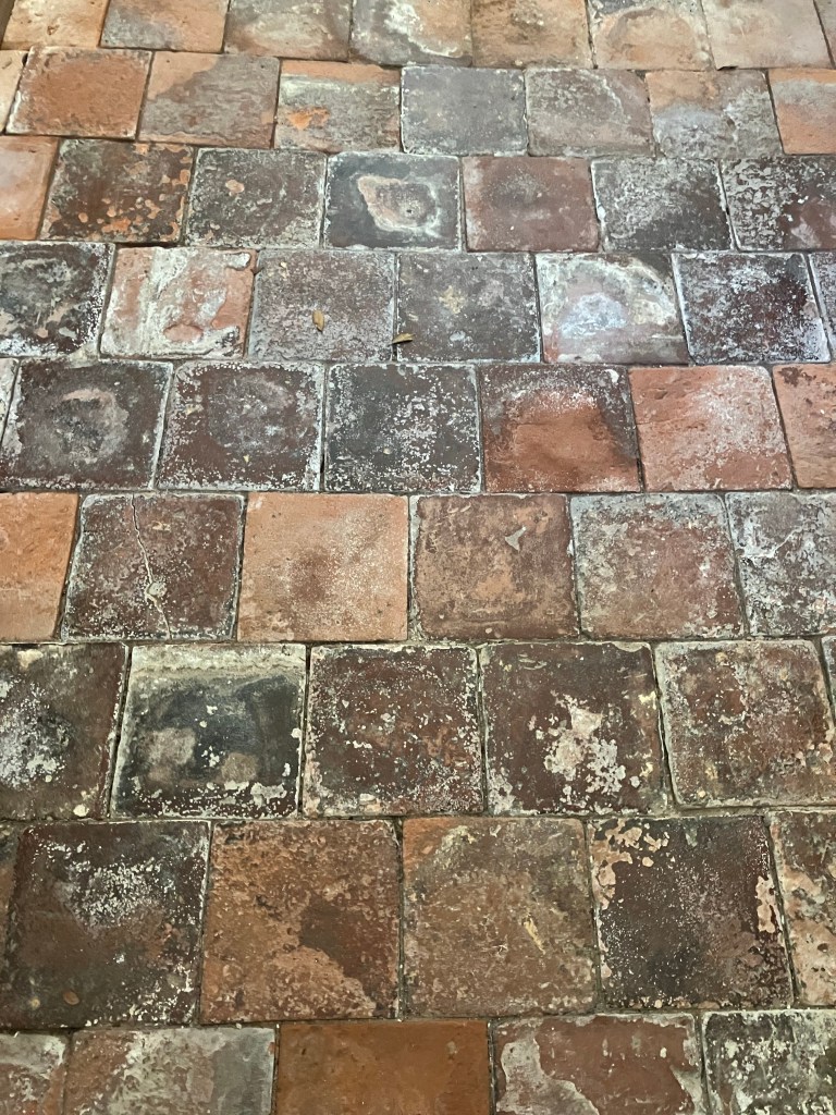 Close view of the worn brick and stone floor tiles