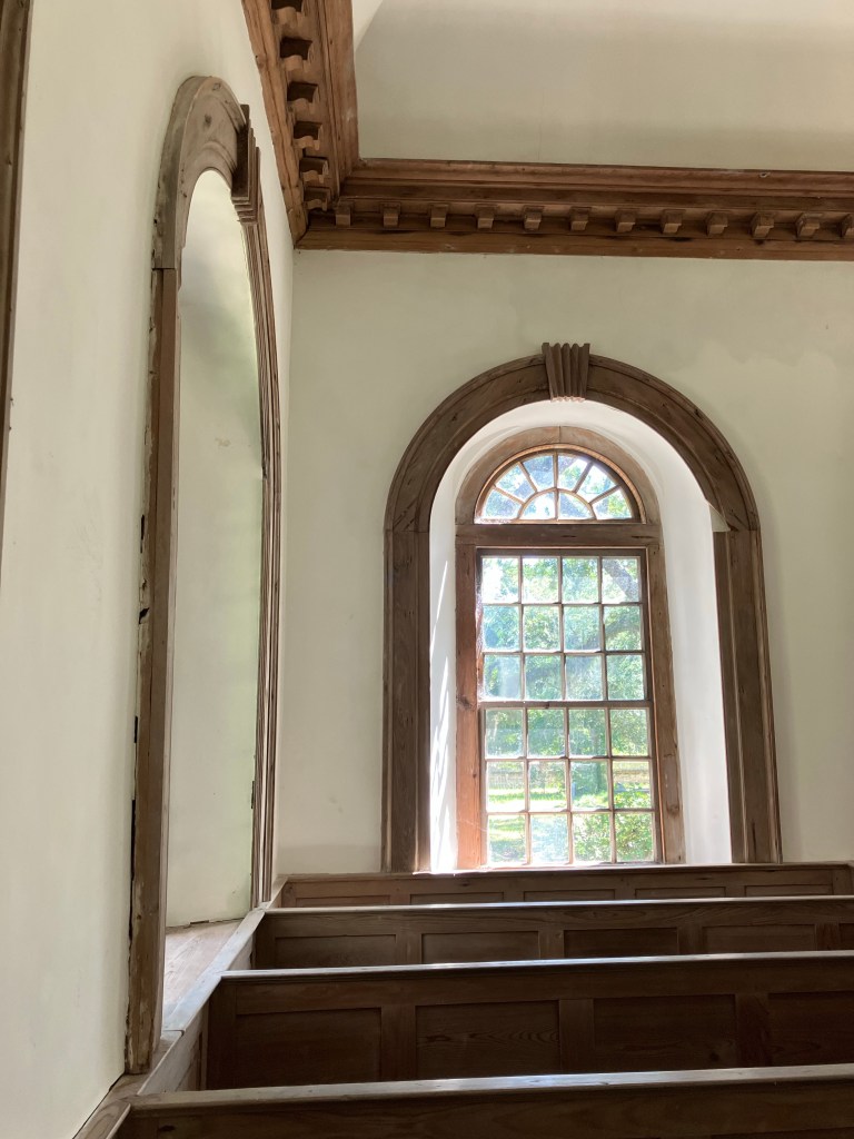 Arched window under the carved cornice