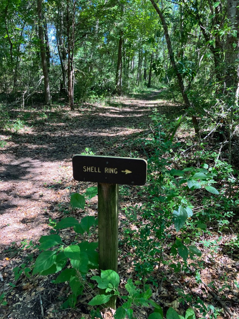 Small trail marker pointing to the Shell Ring