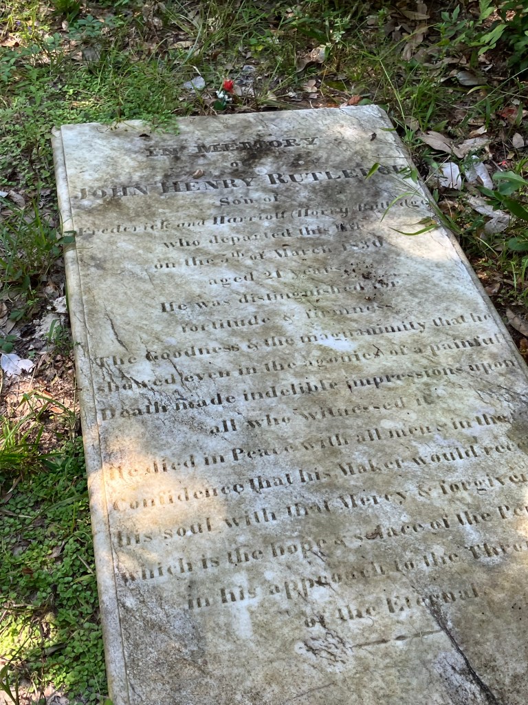 Weathered marble ledger stone of John Henry Rutledge