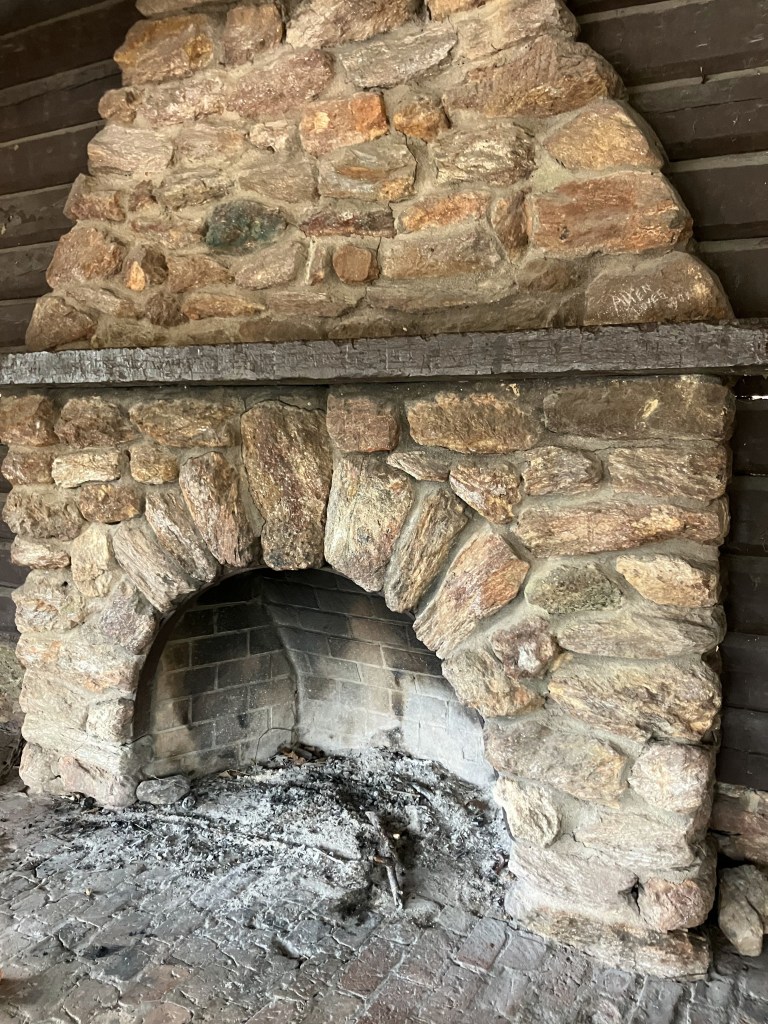 Old stone fireplace with an arched firebox
