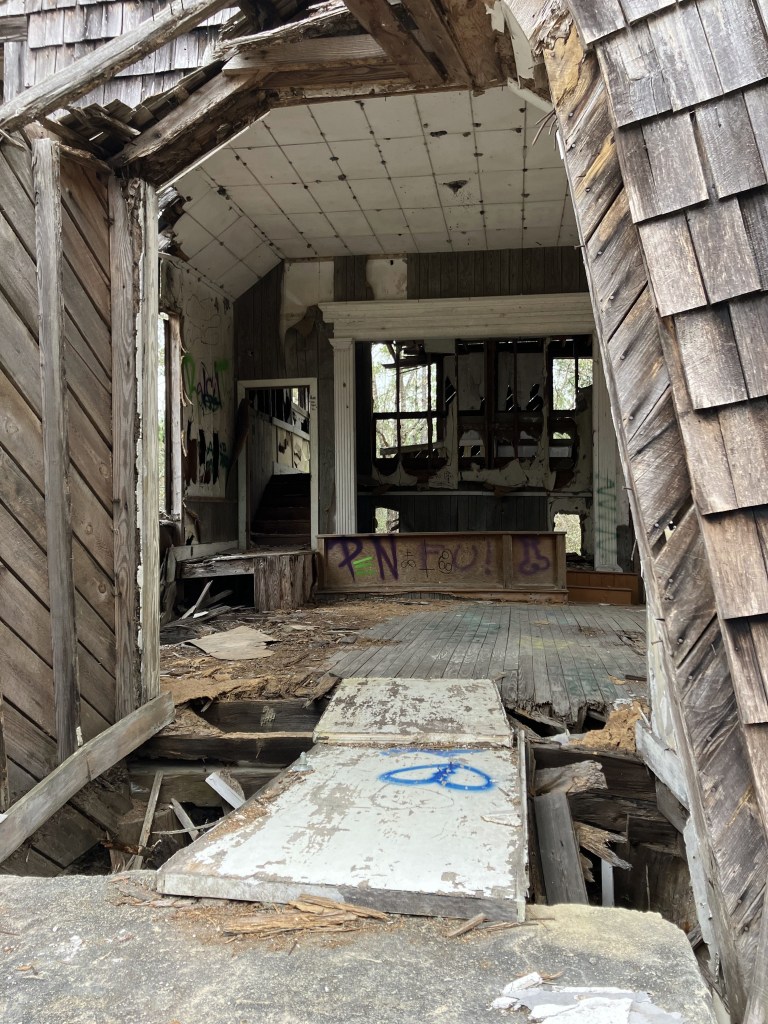 Collapsing interior of the old shingled building