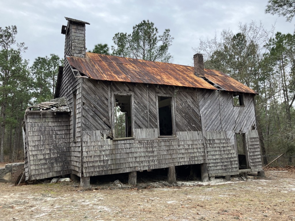 Abandoned shingled building with a rusted tin roof near Halfway Creek