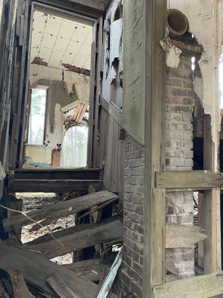 Collapsed interior and brick chimney inside the old building