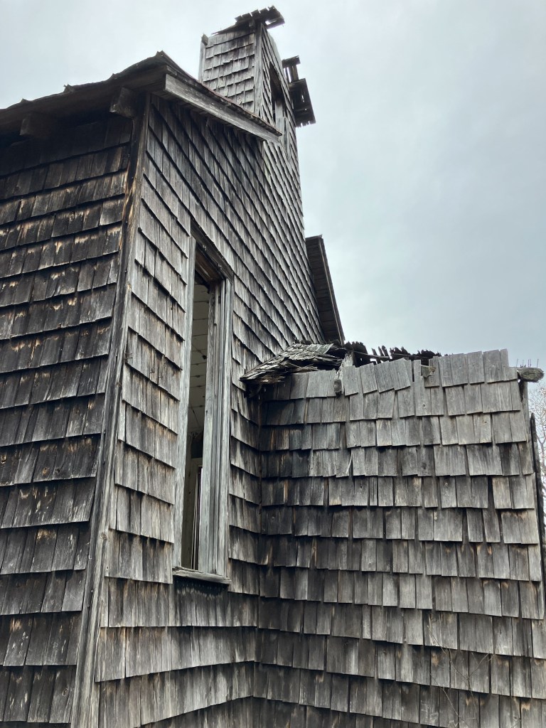 Side of Halfway Creek Church showing the tower and shingles