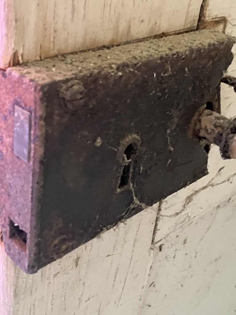 Rusty iron box lock on a door