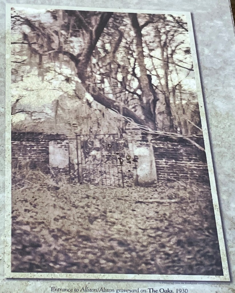 Old photograph of the walled cemetery reproduced on a sign