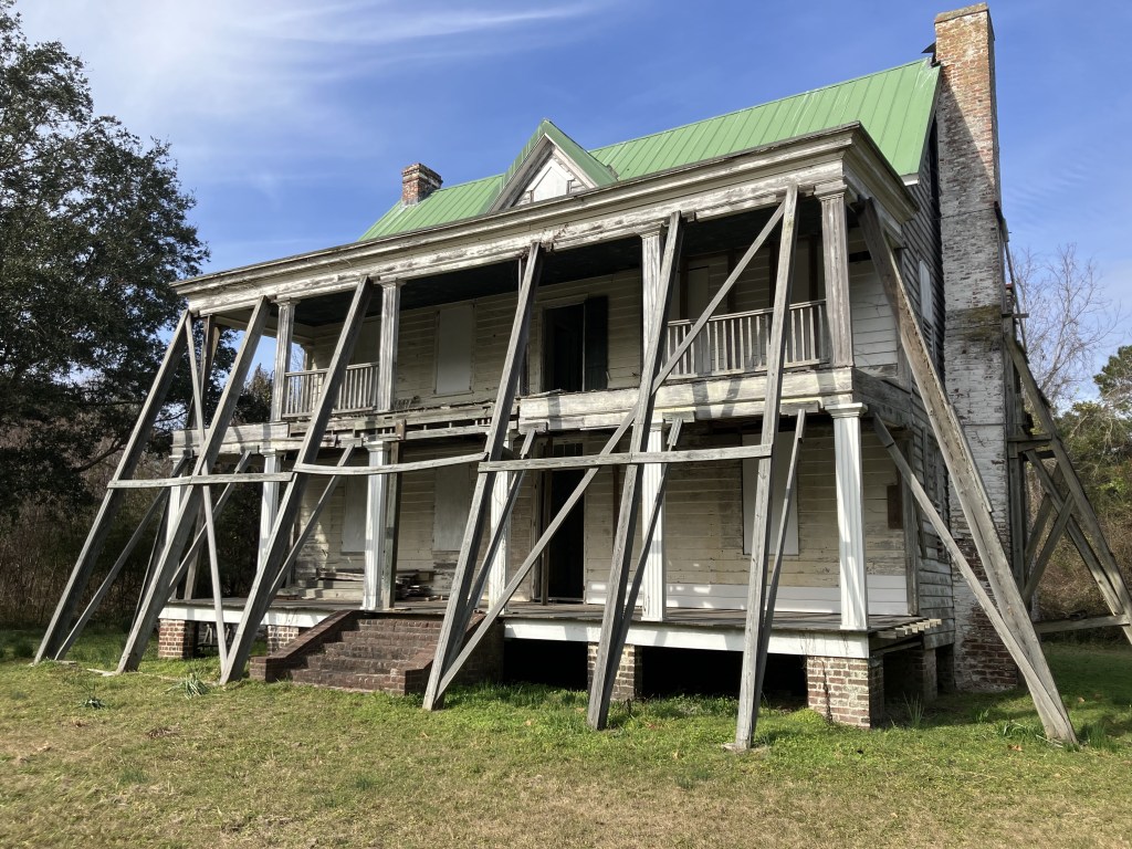 Side view of the Tibwin house with timber bracing along the porches