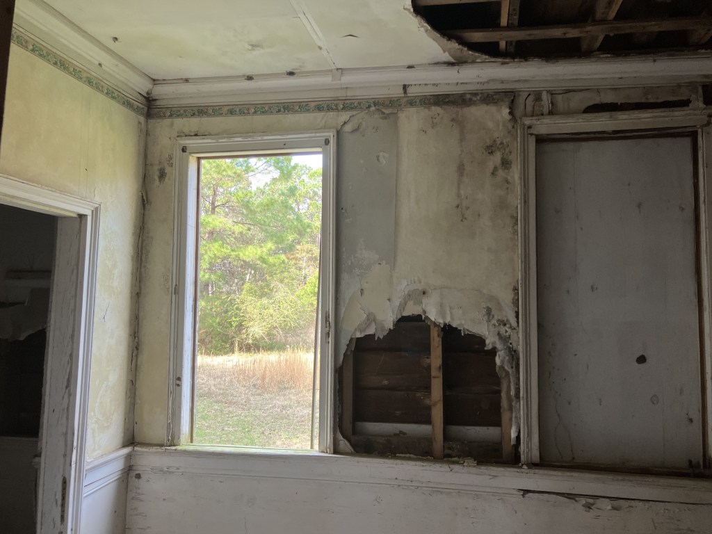 Room with a window and peeling walls