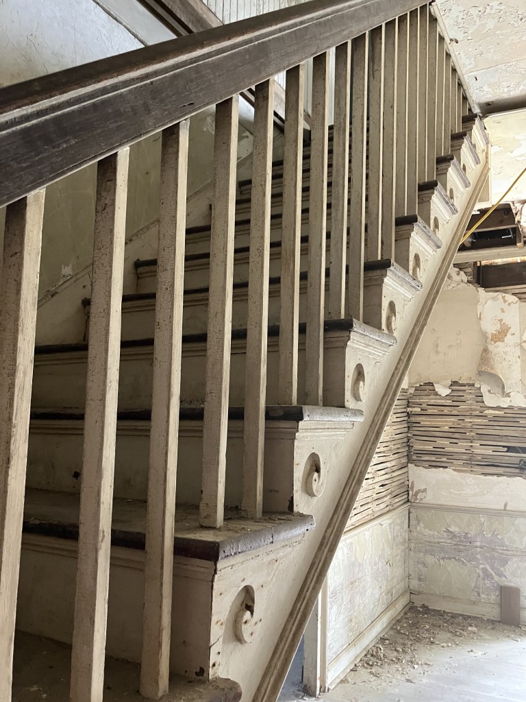 Wooden staircase with square balusters inside the Tibwin house