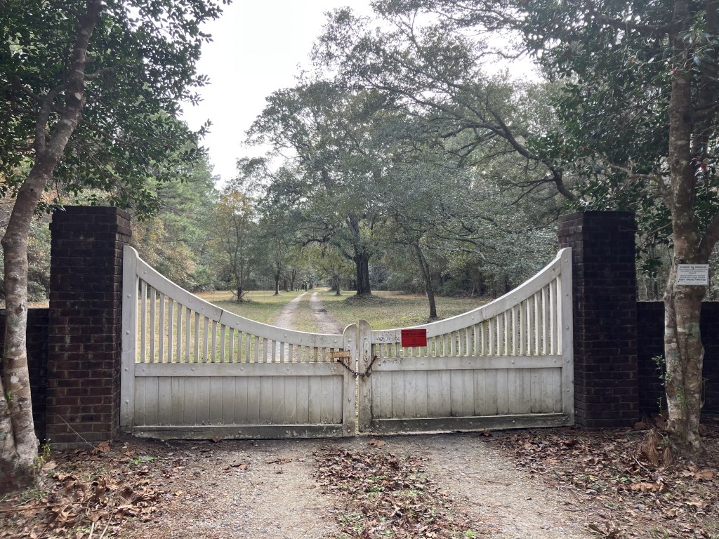 White gate between brick posts at the Tibwin Plantation entrance
