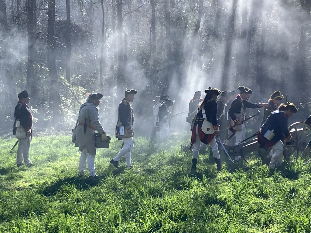Cannon crew working in the sunlit smoke