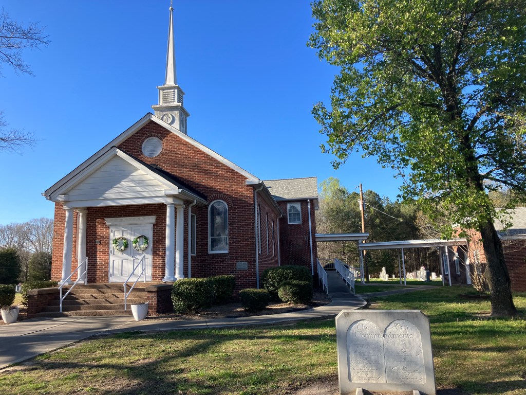 Red brick Mary's Grove Community Church with its white steeple, Cleveland County, North Carolina