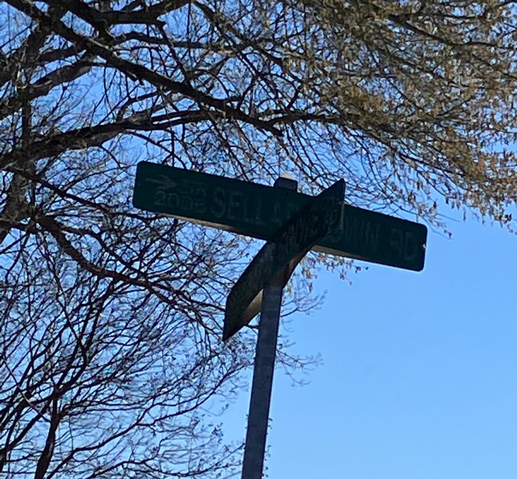Dark silhouette of the Sellartown Road street sign against the sky