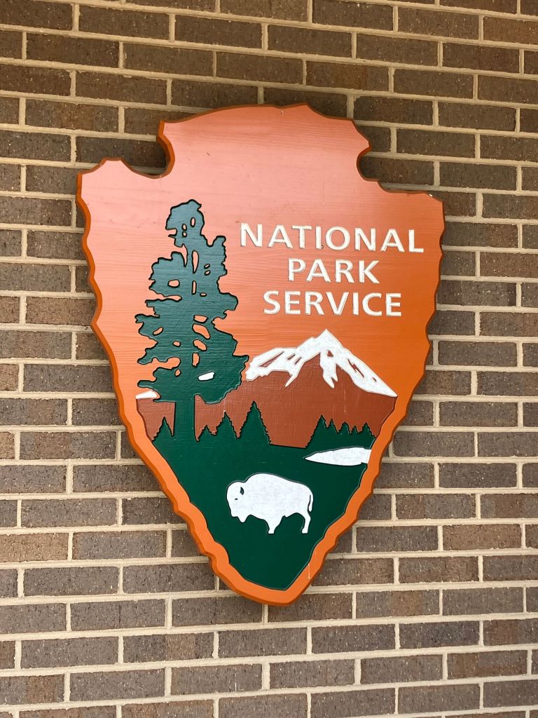 National Park Service arrowhead emblem on a brick wall at Cowpens National Battlefield