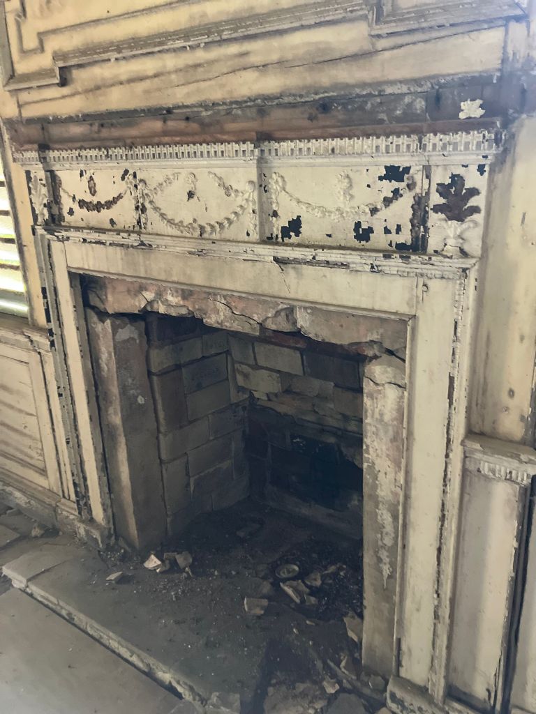 Fireplace with a carved mantel and swag frieze