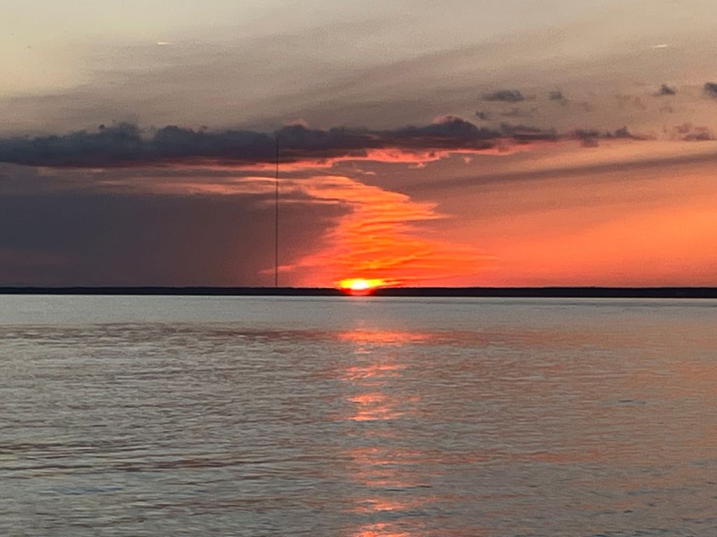 Orange sunset over the water seen from the boat