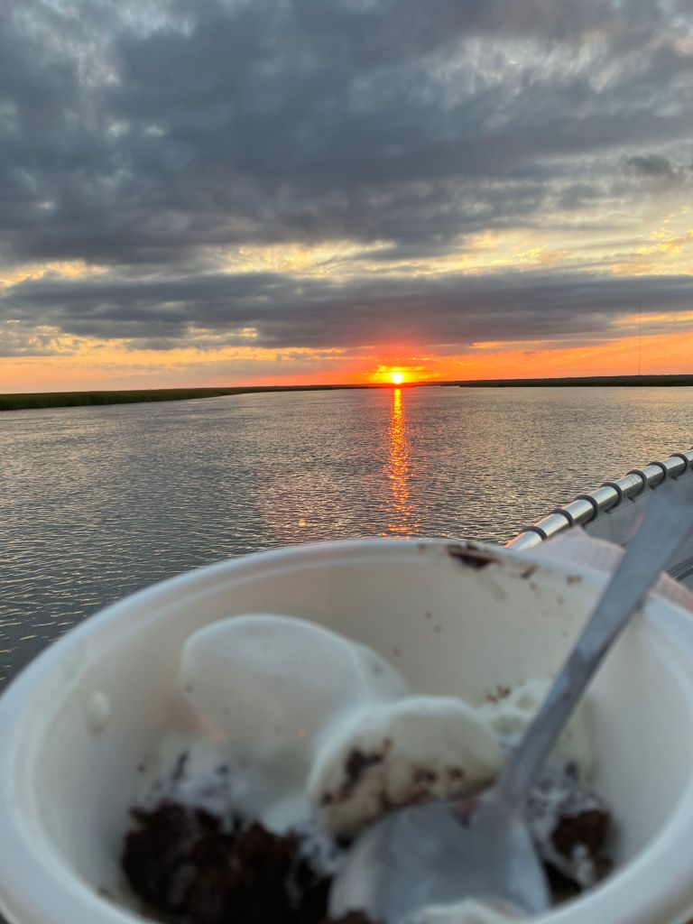 Cup of ice cream dessert on the boat at sunset