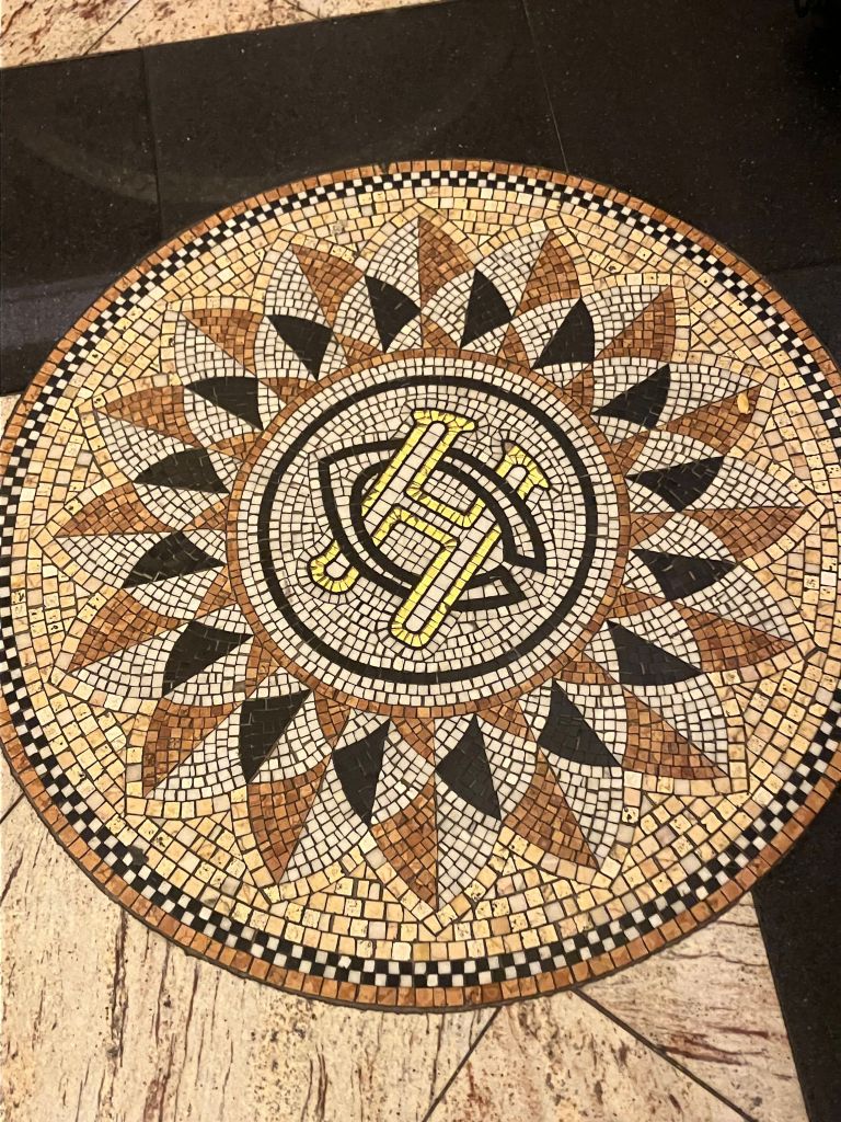 Round mosaic tile medallion with a star pattern in the hotel floor
