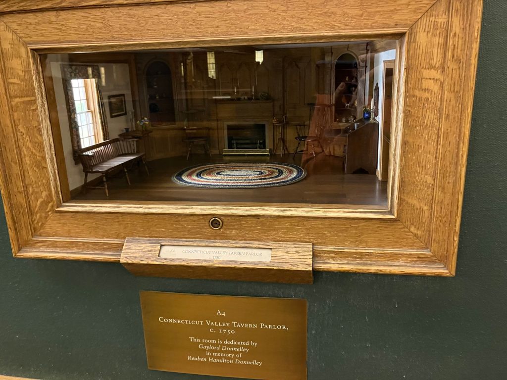 A Thorne miniature room framed in its gallery display case
