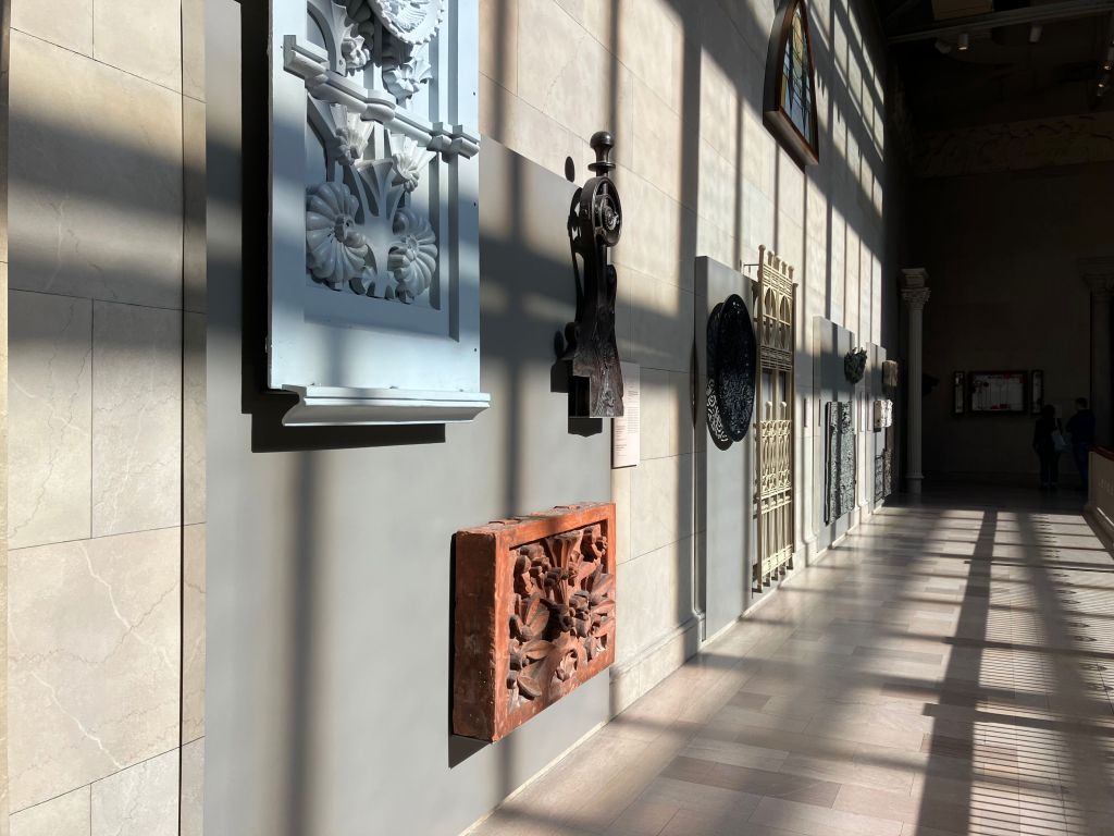 Long museum gallery with light streaming across the floor