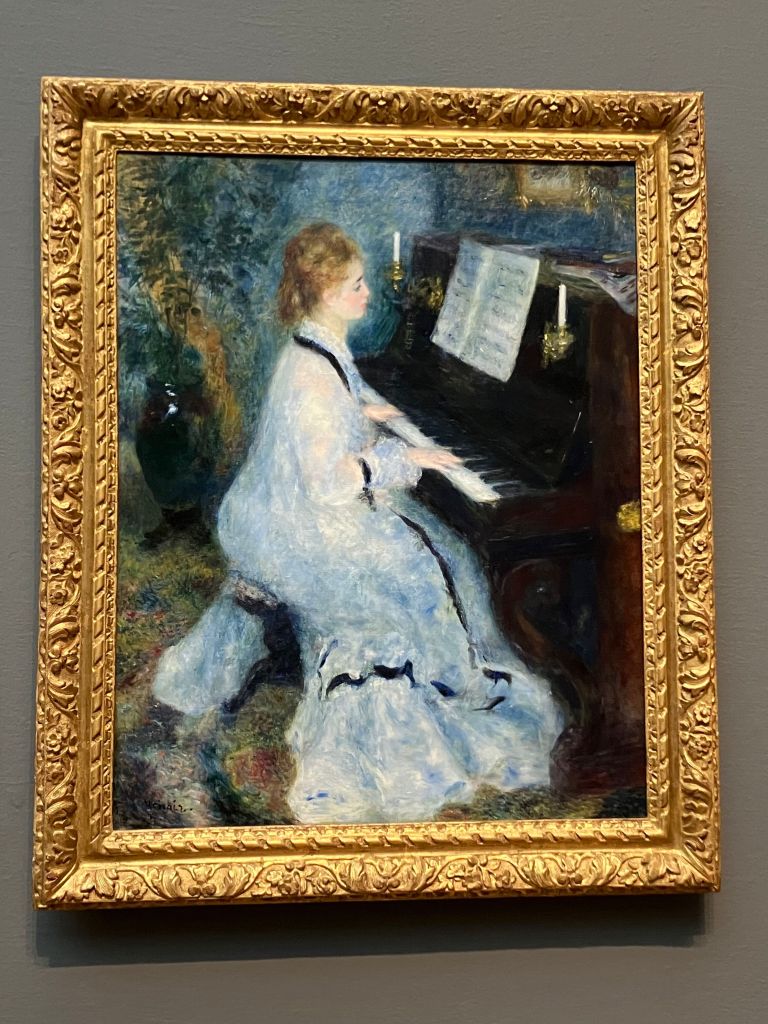 Renoir's painting of a woman in a white dress playing the piano, at the Art Institute of Chicago