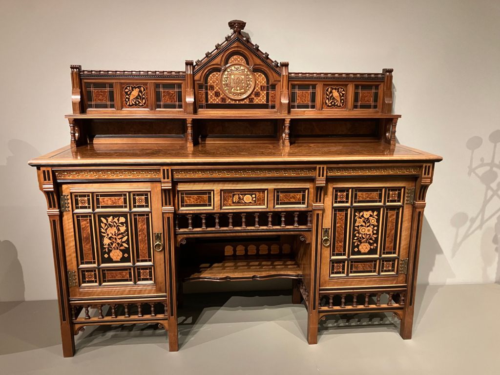 Ornate carved wooden desk on display