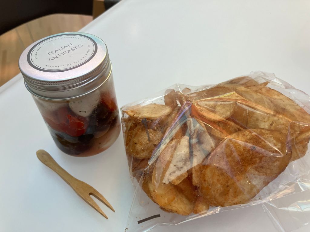 Jar of fruit and a pastry on a café table