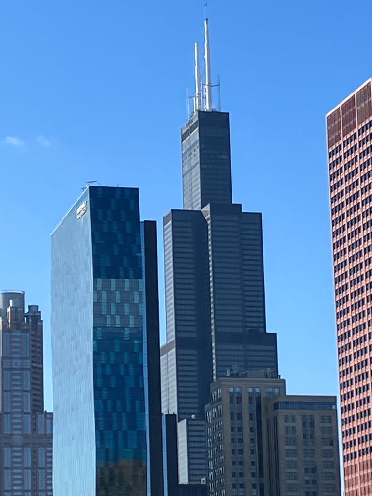 Willis Tower and neighboring skyscrapers against a blue sky